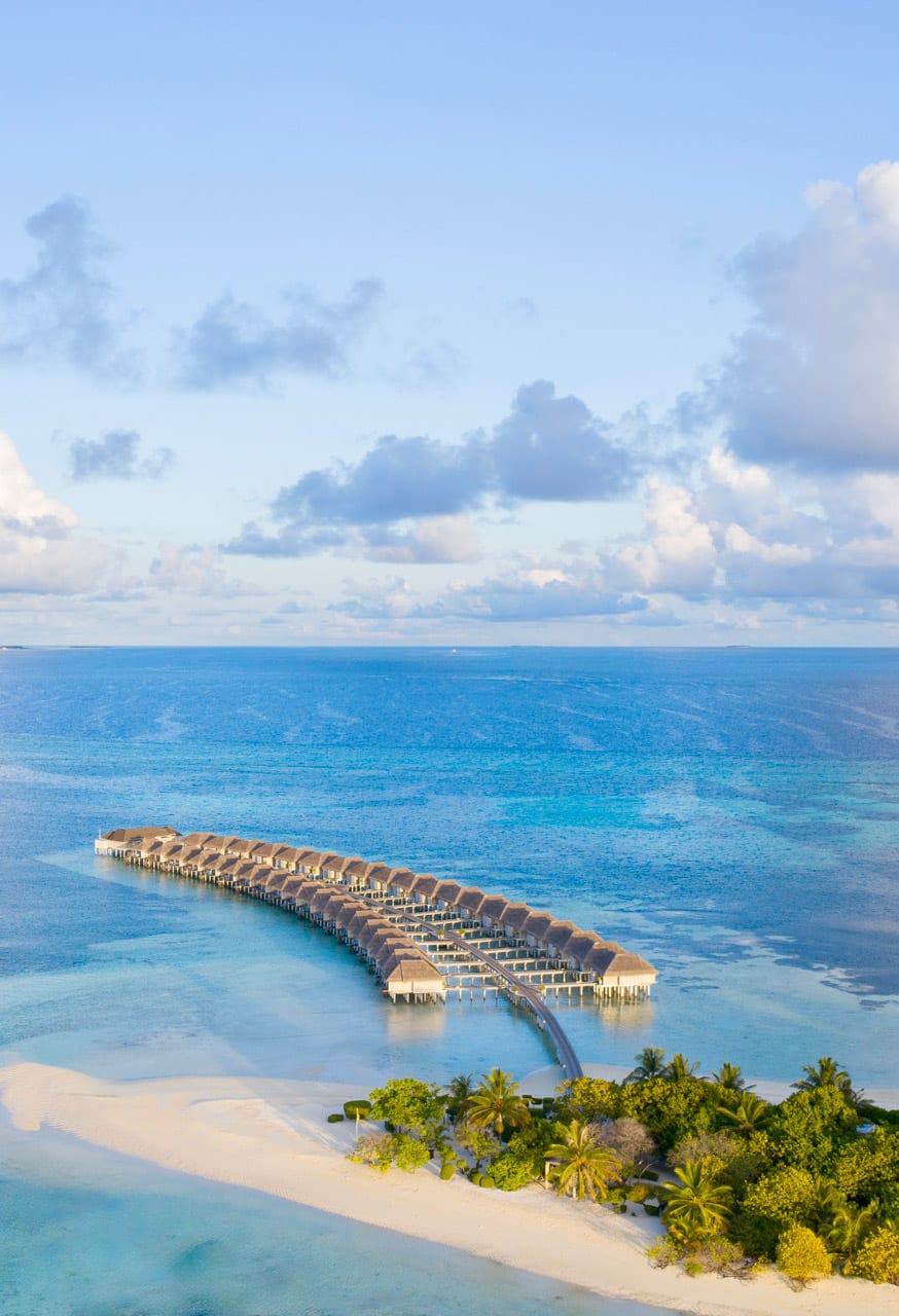 Aerial view of LUX South Ari Atoll's overwater villas along the Dhidhoofinolhu reef