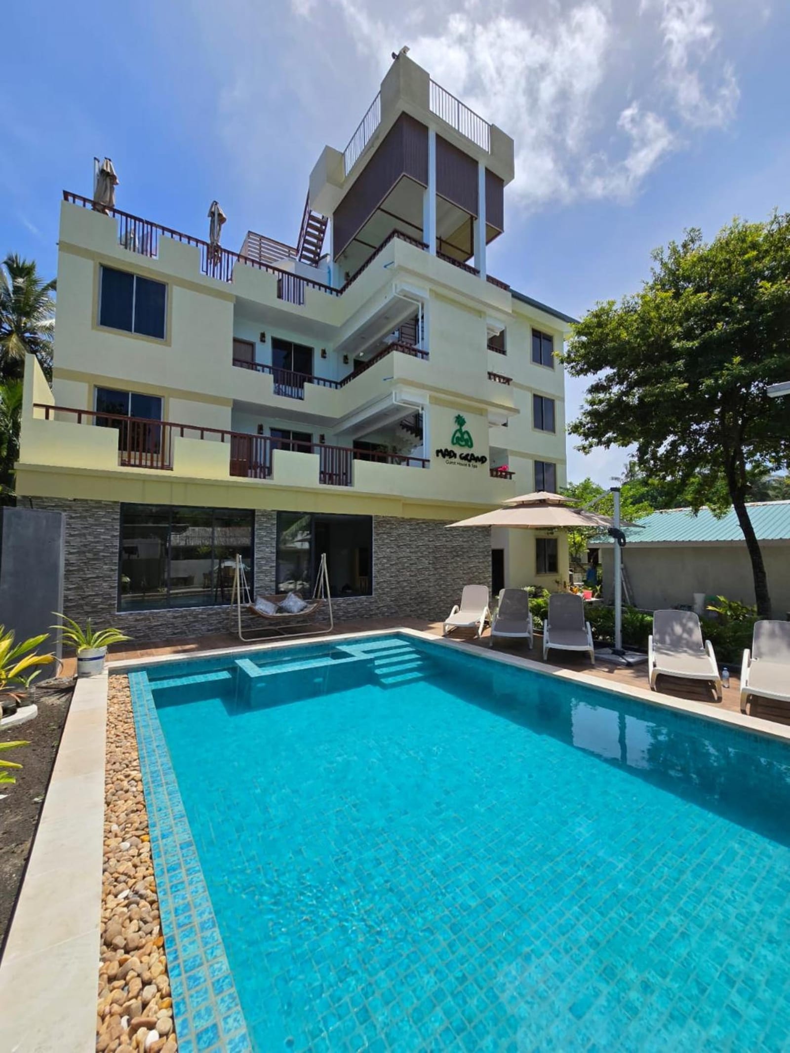 Outdoor pool and loungers at Madi Grand Maldives Fulidhoo