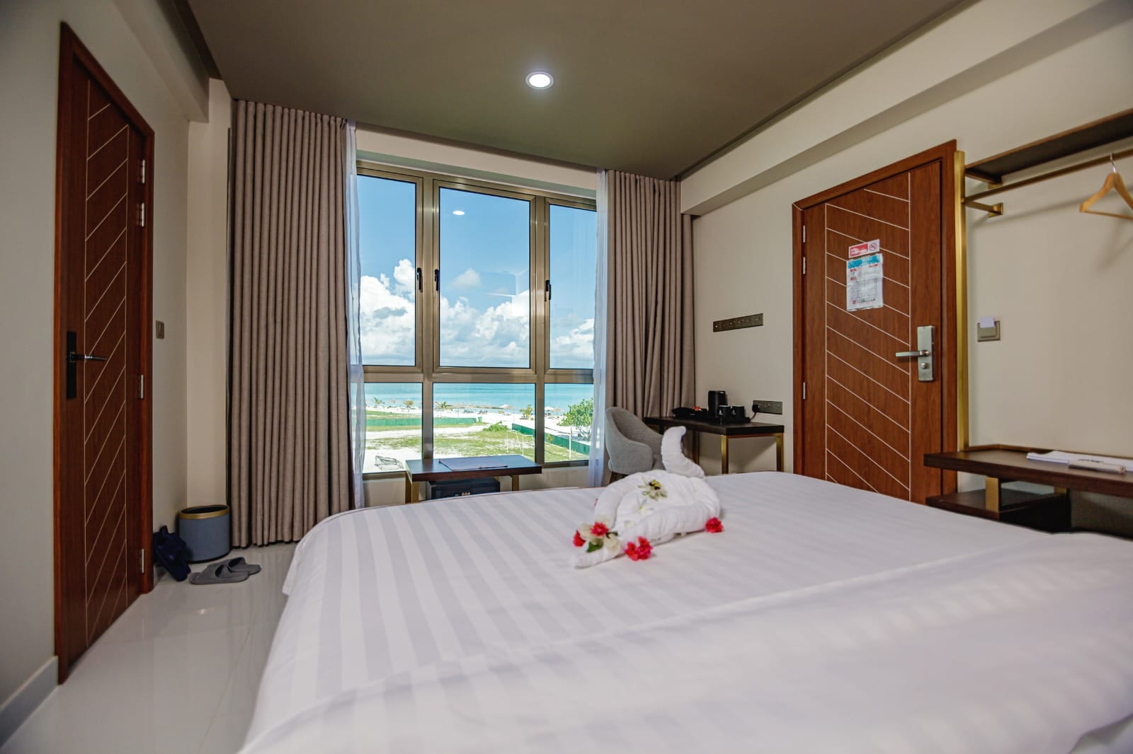Royal Villa rooftop with pale loungers facing the lagoon